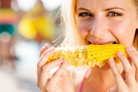 graphicstock-close-up-of-face-of-woman-in-bikini-eating-corn-summer-and-heat_SOQEmWmBfW-1024x683