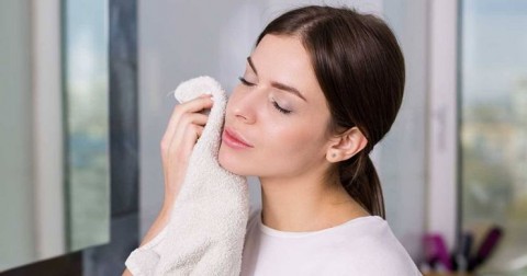 Woman-patting-her-face-dry-with-towel
